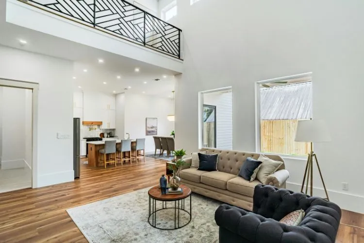 bright and spacious living area with high ceilings, modern furnishings, and an open-concept design