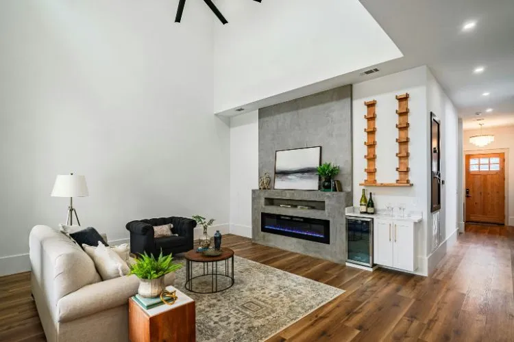 modern living space with high ceilings, a sleek fireplace, and a cozy seating arrangement, featuring a neutral color scheme