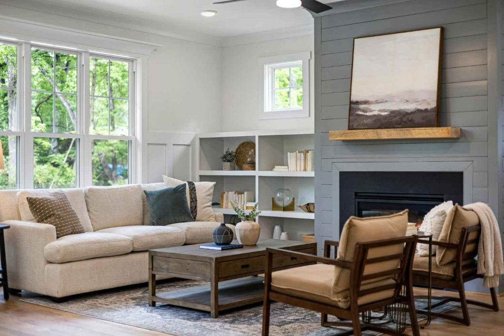 Living room with comfortable seating, fireplace, and nature views