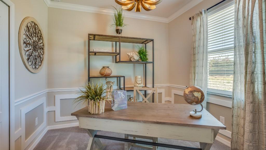 Home office with desk, shelves, and decorative accents