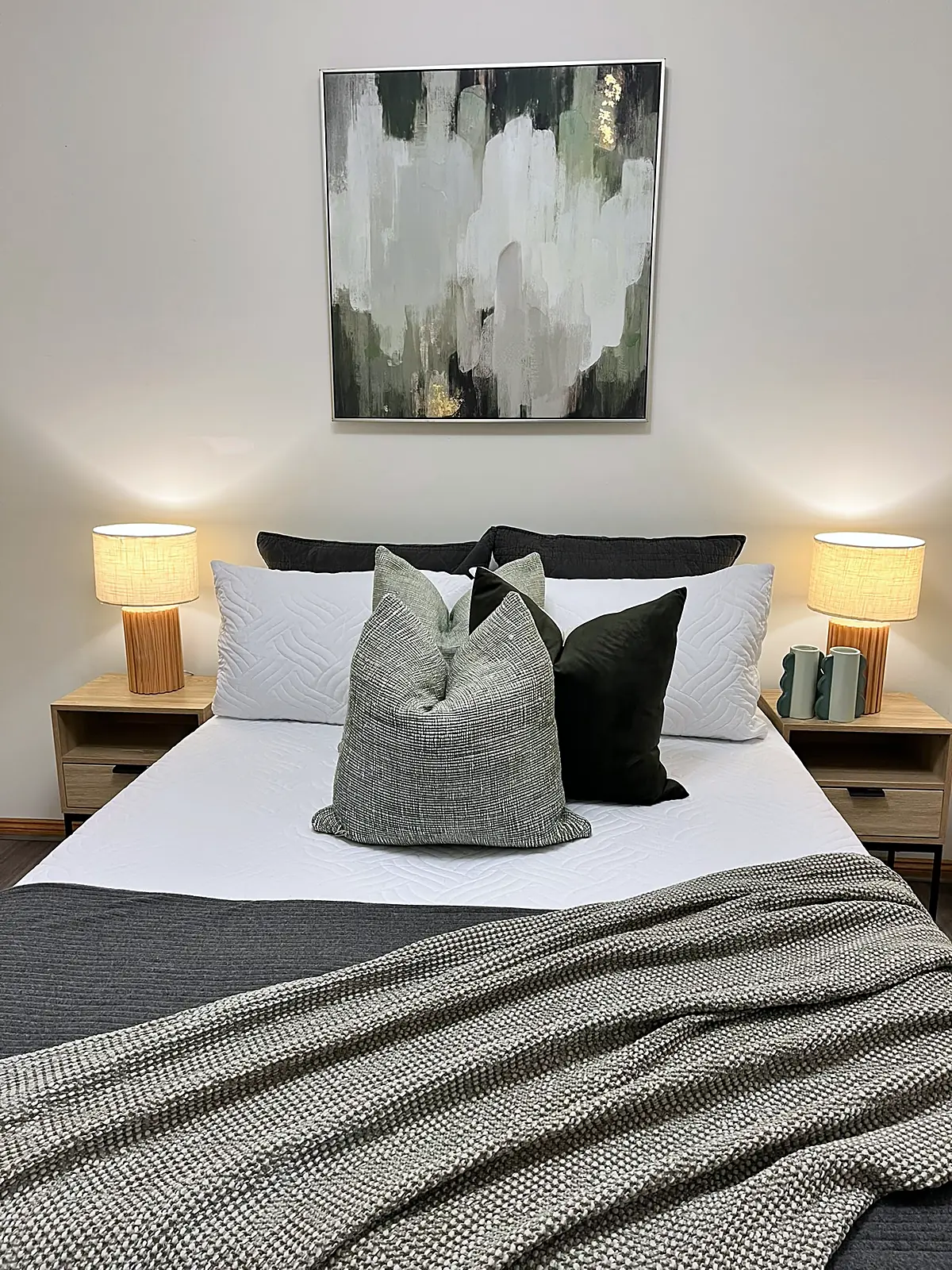 Bedroom staged with green cushions and grey throw in an Altona Meadows home