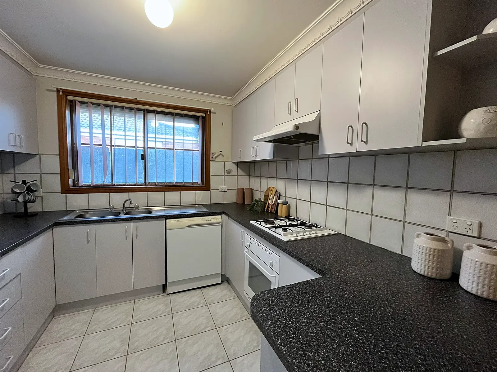 Kitchen styled with canisters and boards in an Altona Meadows home