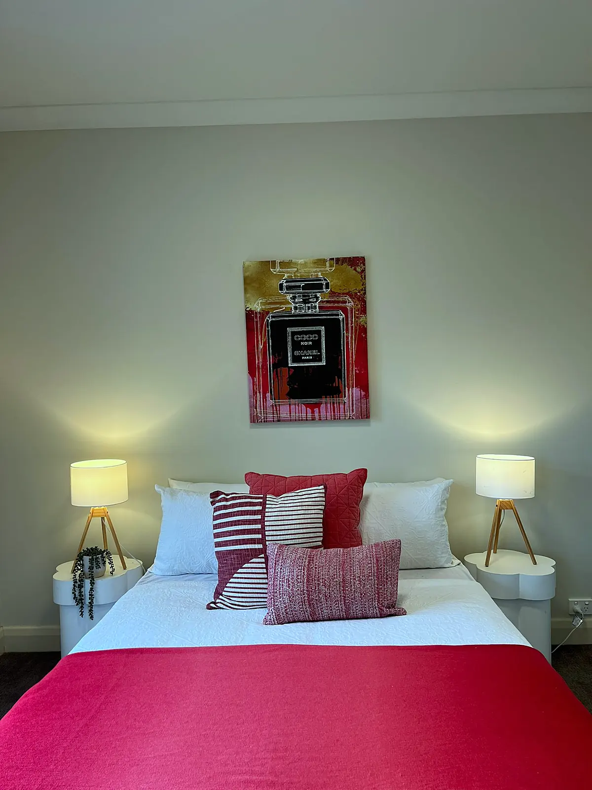 Bedroom staged with red linen and artwork in a Balwyn home