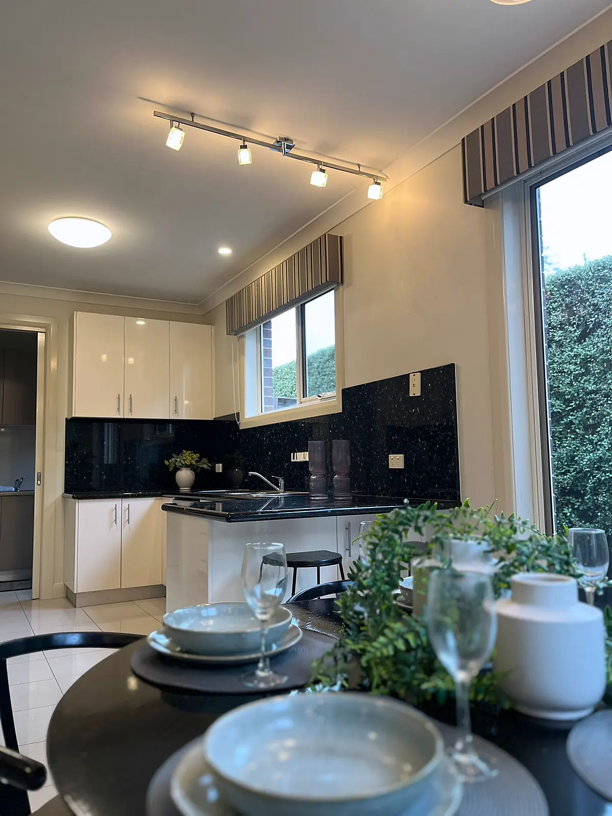 Round dining table set beside the kitchen in a staged Balwyn home
