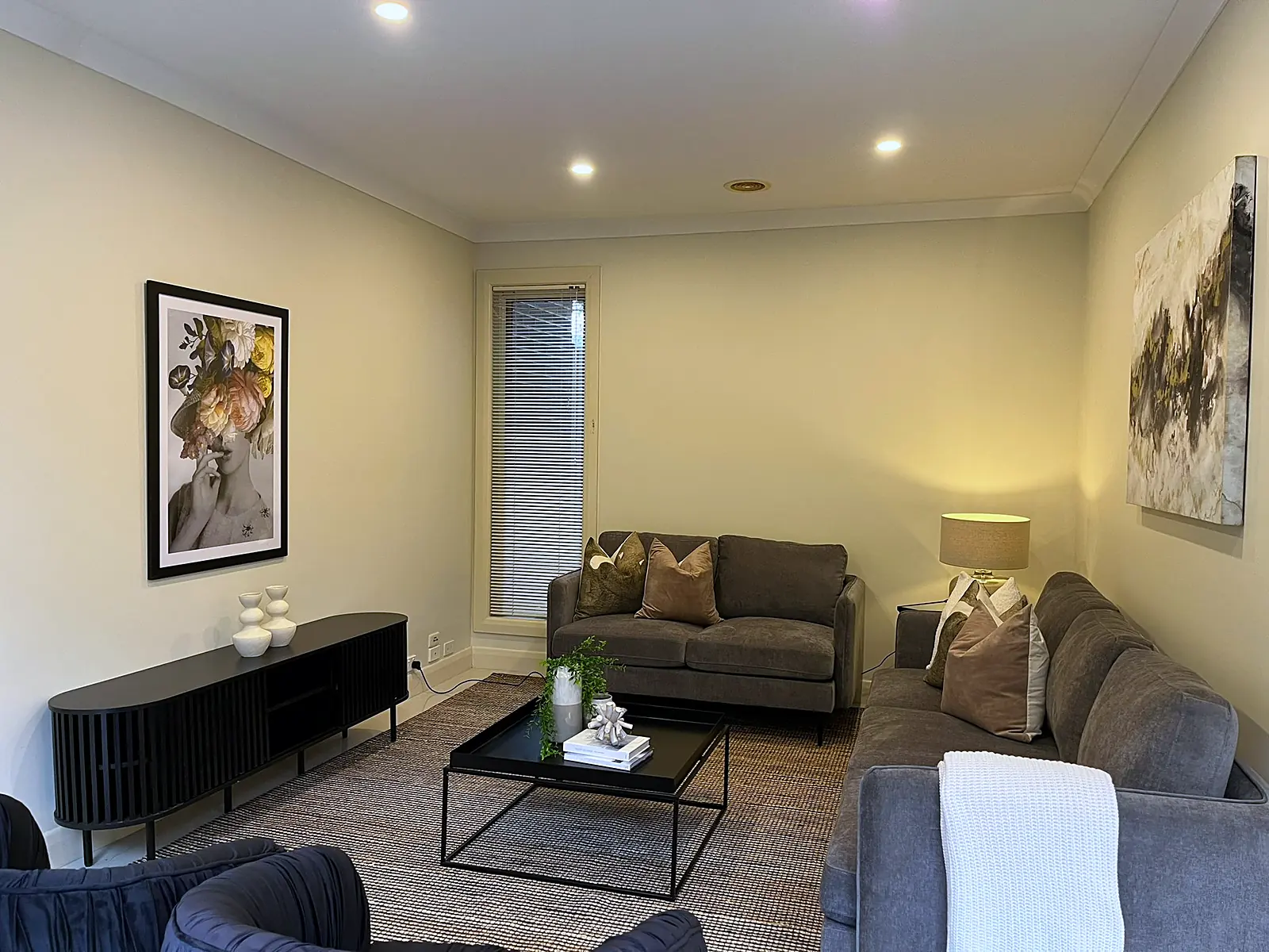 Lounge staged with charcoal sofas and black coffee table in a Balwyn home