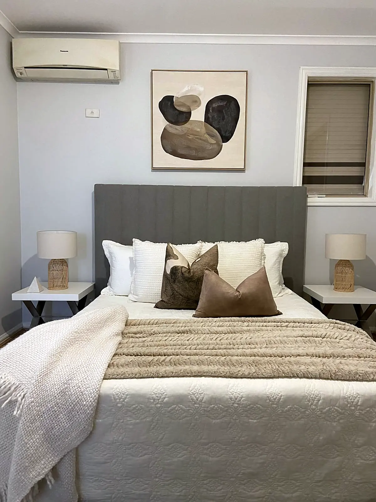Main bedroom staged with grey bedhead and warm neutral linen in a Braybrook home