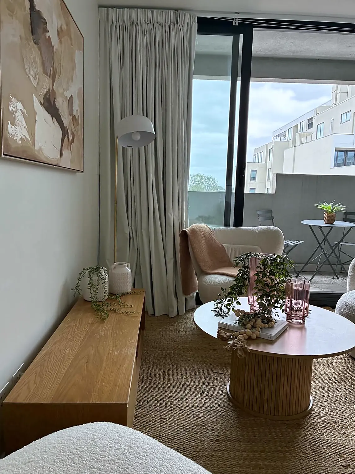 Apartment living room opening to a balcony, staged in Brunswick
