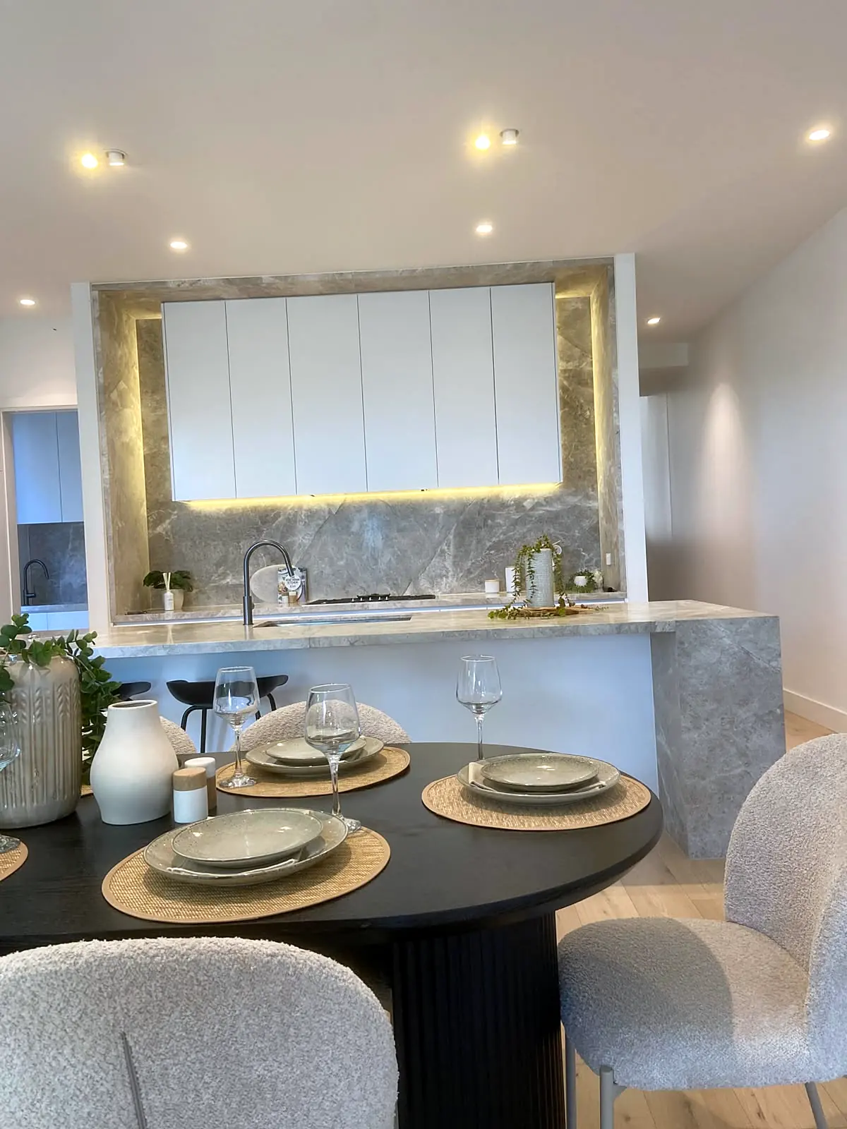 Dining table set beside the marble kitchen in a staged Bulleen home
