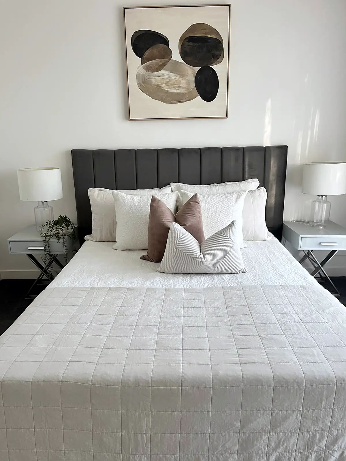 Bedroom styled with dark bedhead and white linen in a Bundoora home