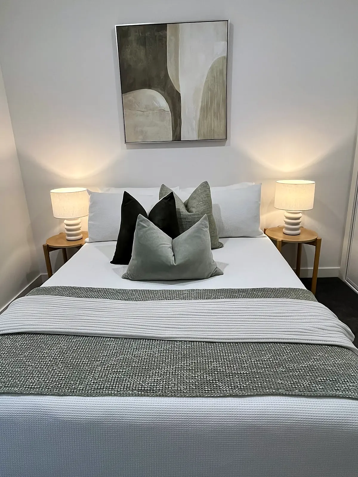 Bedroom staged with sage cushions and throw in a Bundoora home
