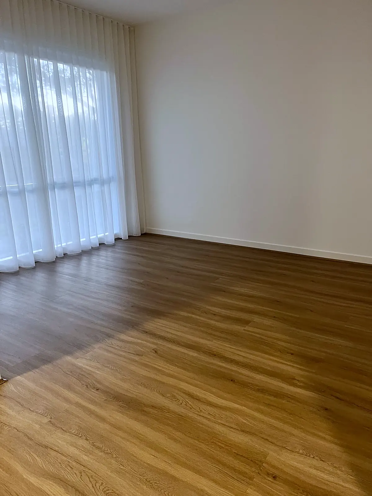 Empty living room with sheer curtains before staging in a Bundoora home