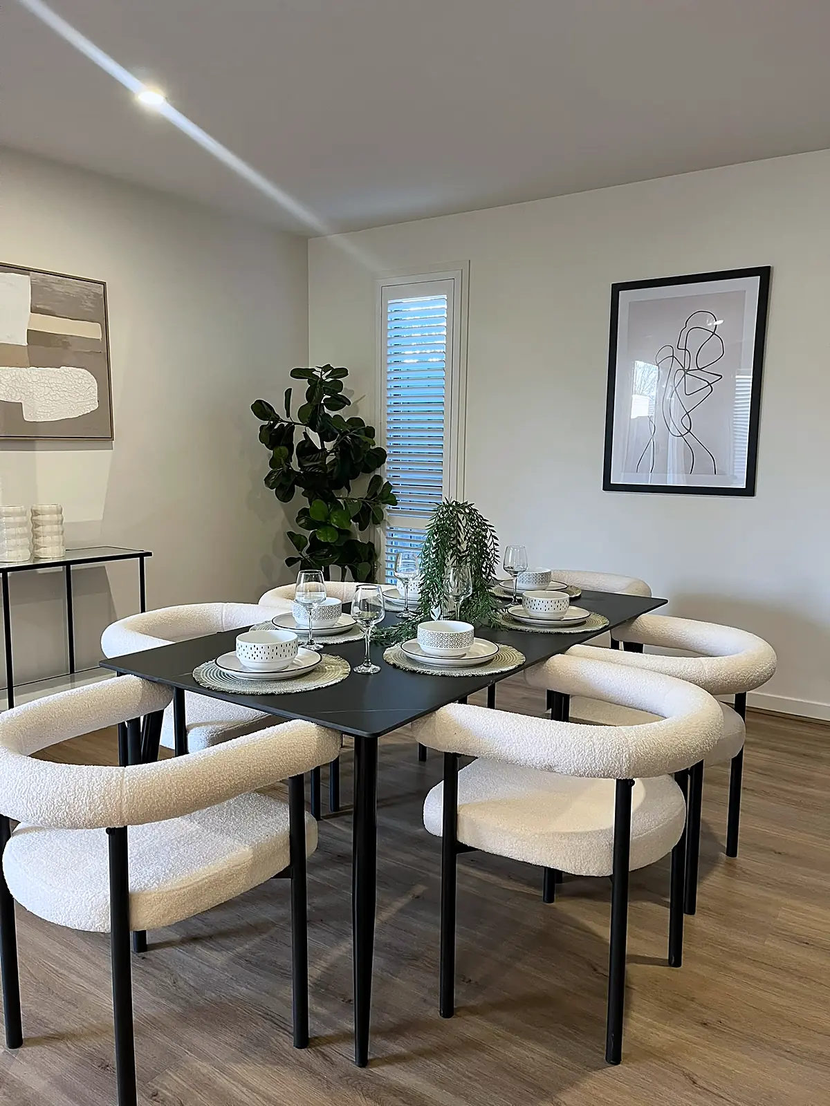 Dining table with boucle chairs in a staged Bundoora home