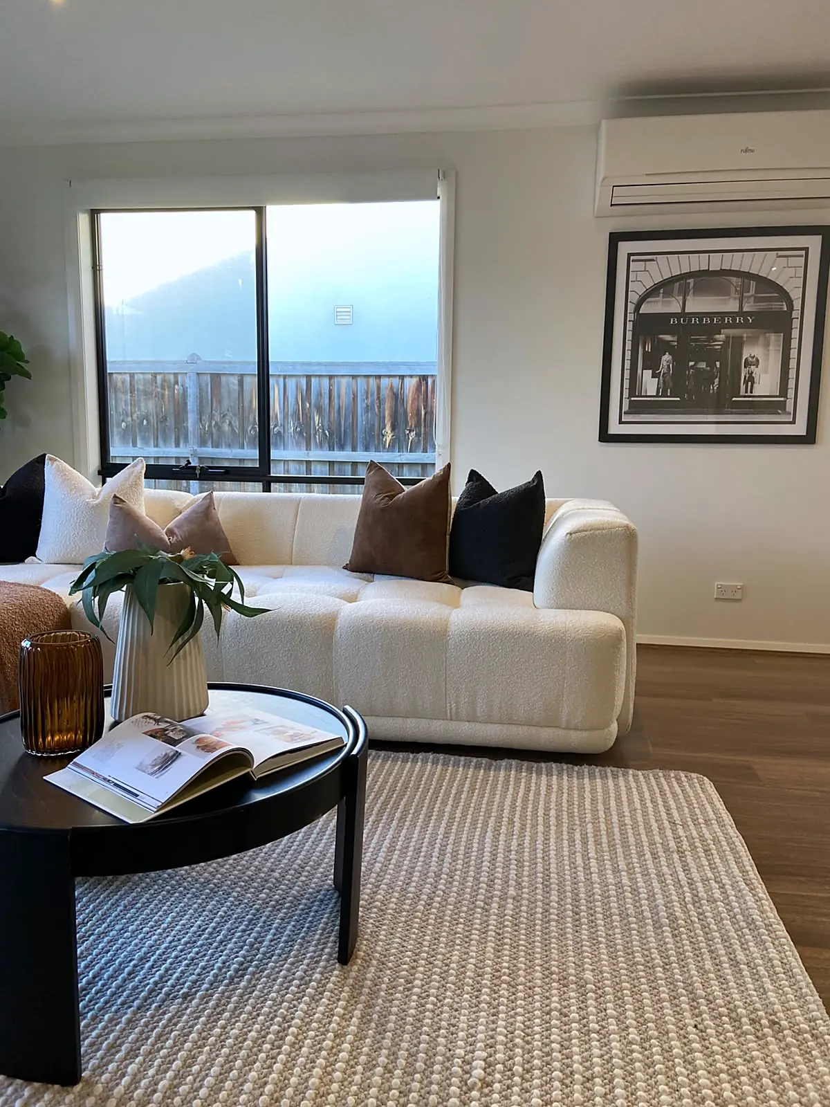 Living room staged with cream sofa and black coffee table in a Burnside Heights home