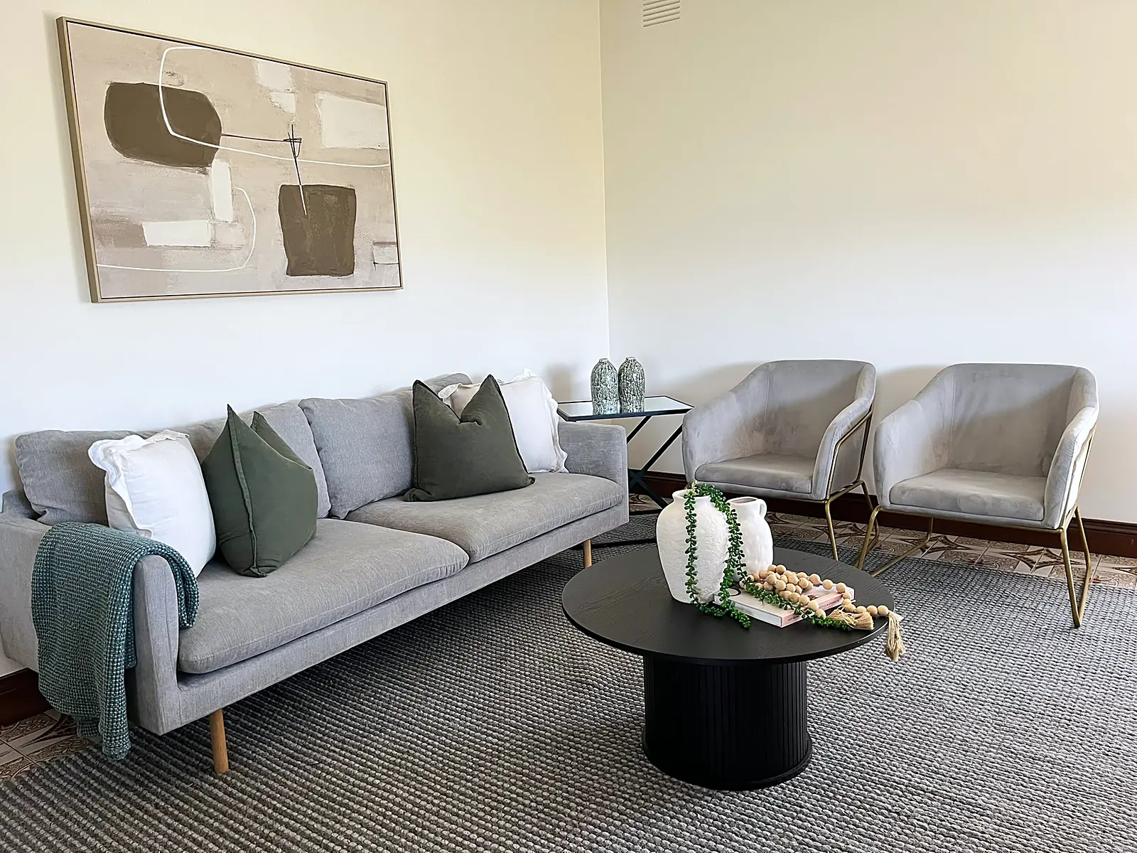 Second living area styled with grey sofa and armchairs in a Chadstone home