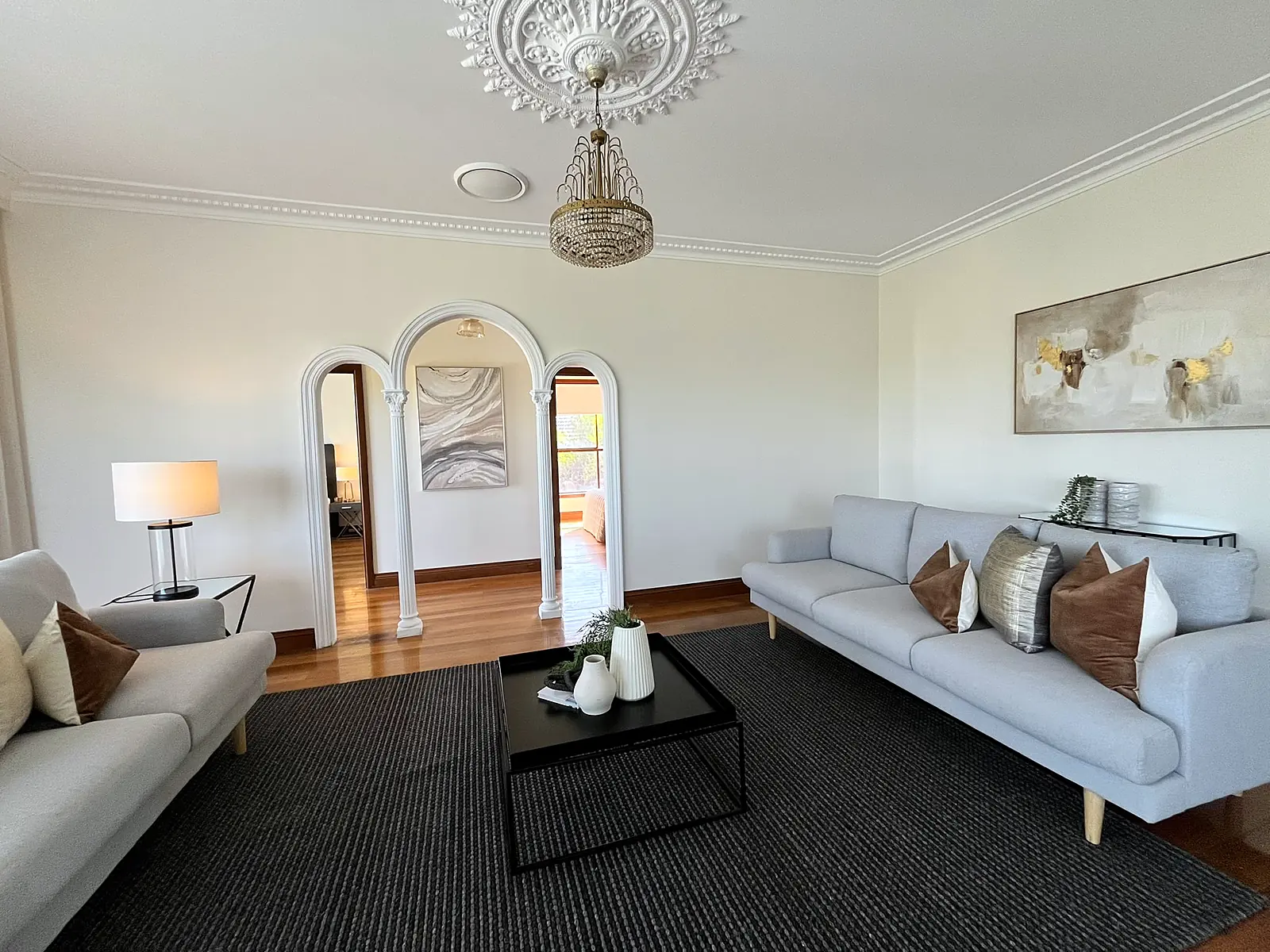 Formal lounge with arched doorways staged with twin sofas in a Chadstone home