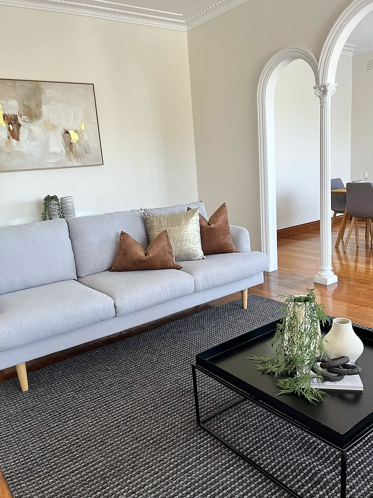 Living room staged with pale sofa and black coffee table in a Chadstone home