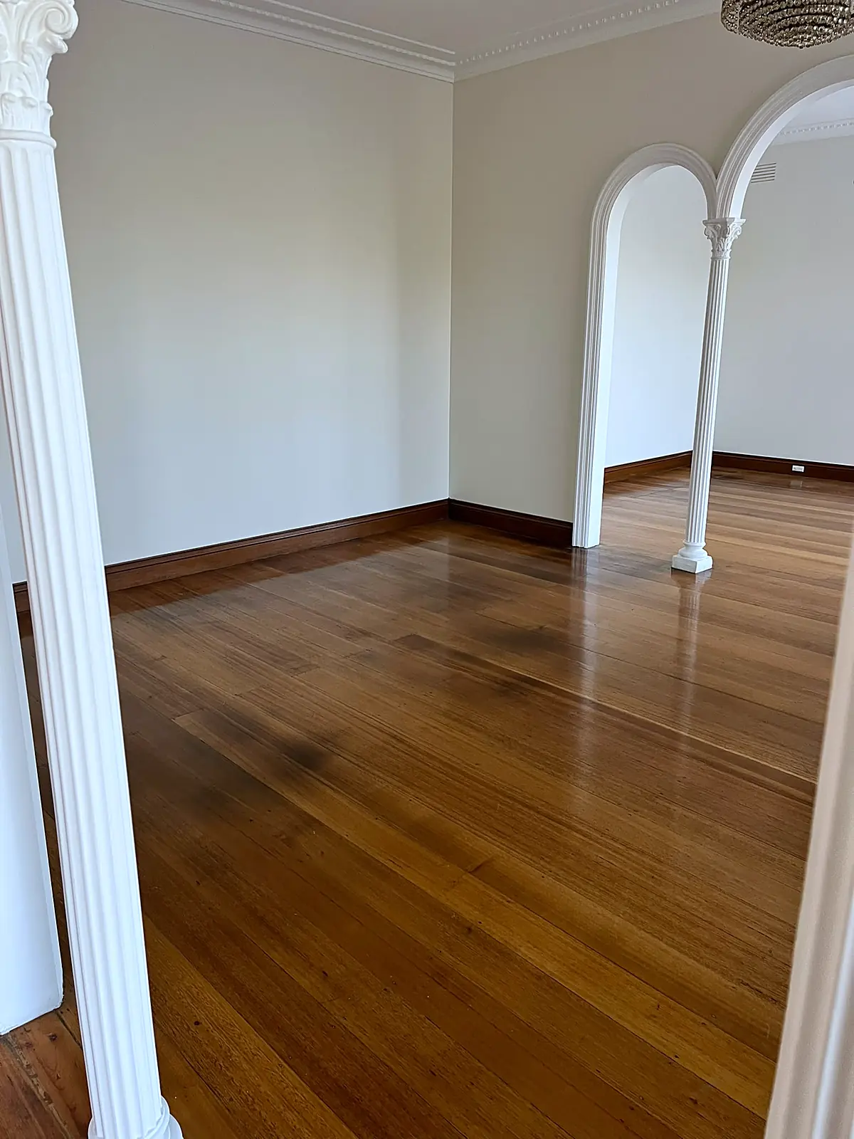 Empty lounge with arched doorway before staging in a Chadstone home