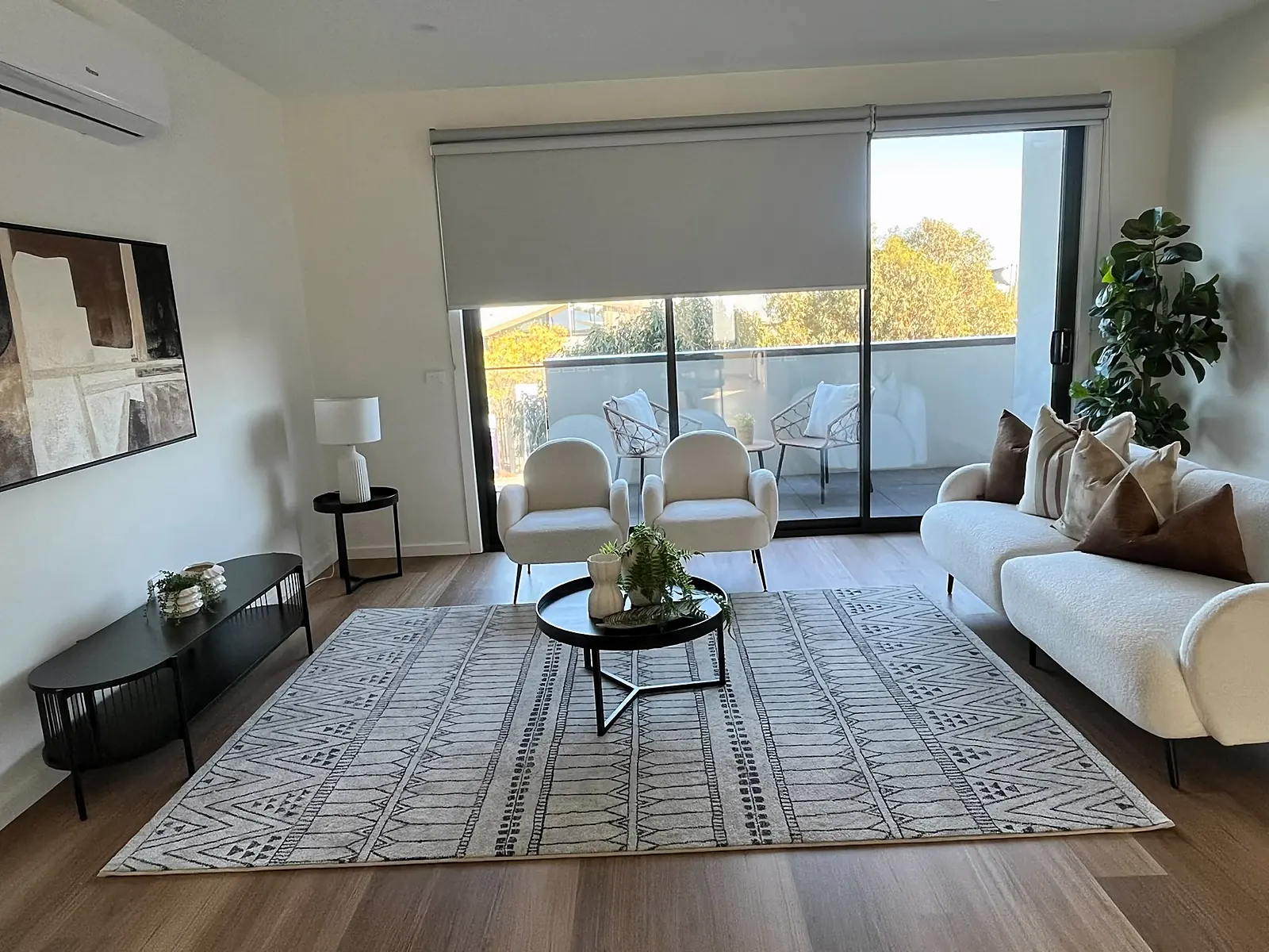 Open living area staged with white sofa and patterned rug in Craigieburn