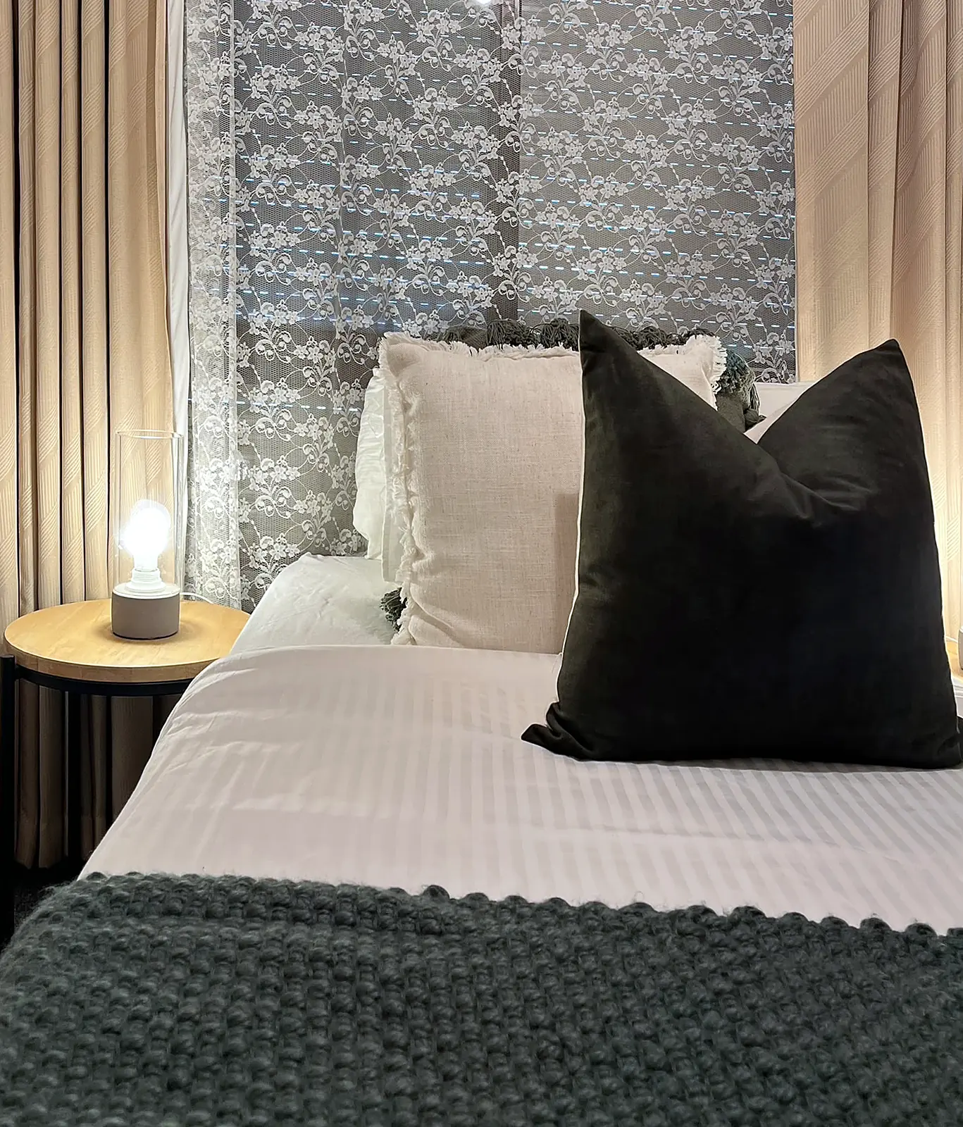 Bedroom with floral feature wall styled in white and dark green in a Deer Park home