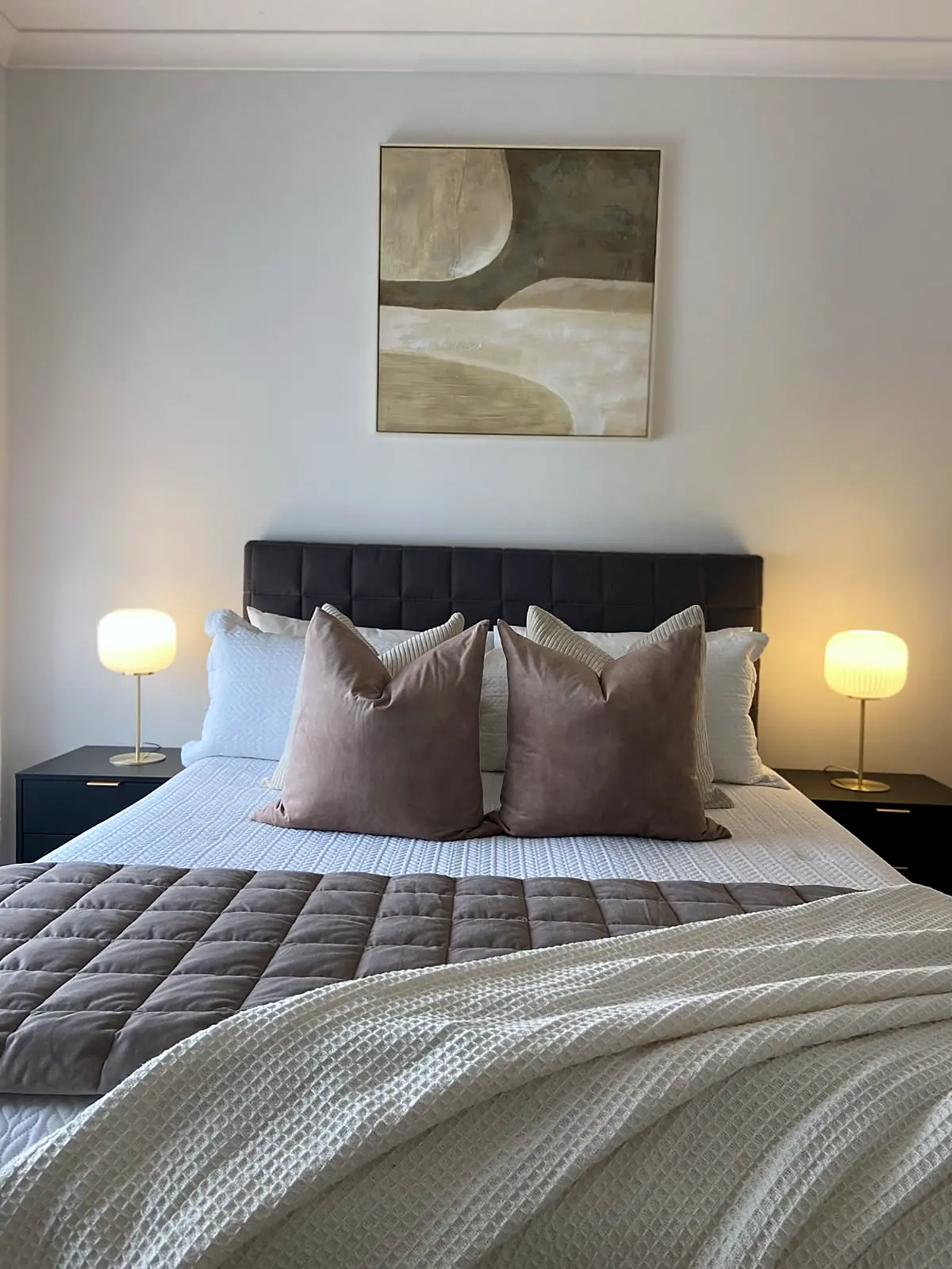 Main bedroom staged with dark bedhead and mauve cushions in a Diggers Rest home