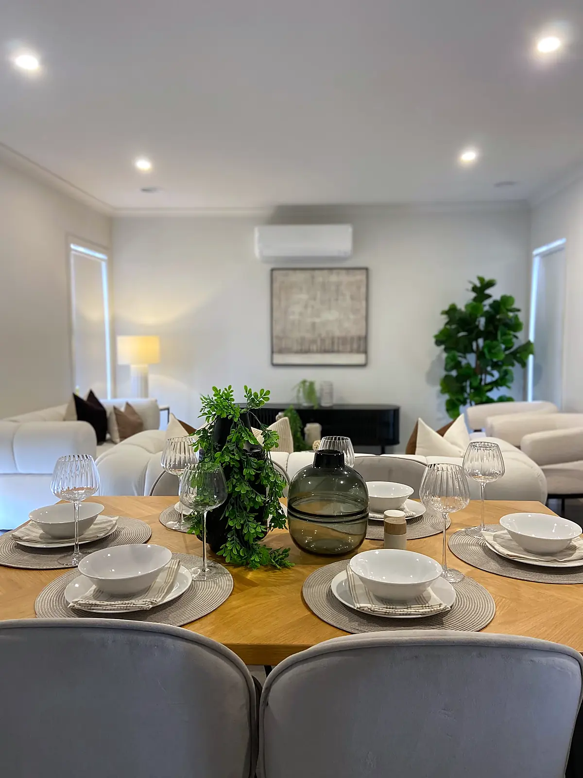 Timber dining table set for six beside the lounge in a staged Diggers Rest home