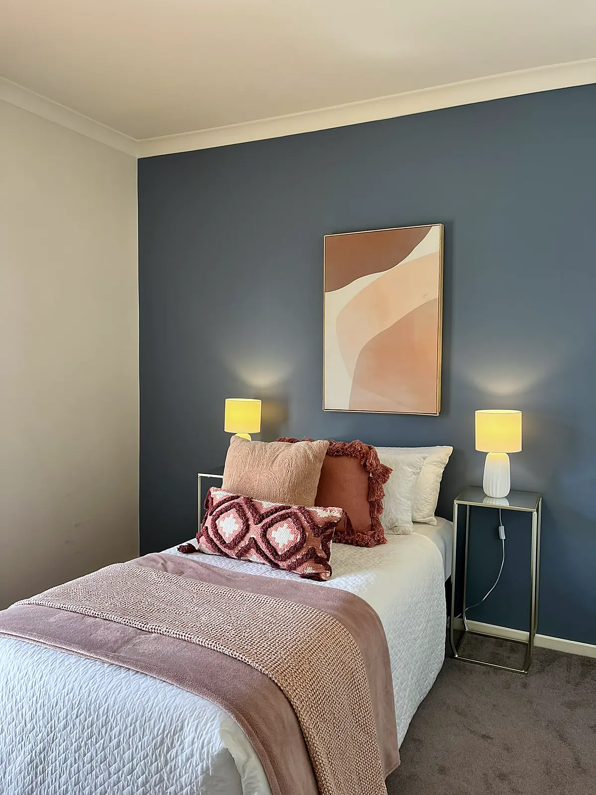 Bedroom with feature wall styled in blush linen in a Doreen home