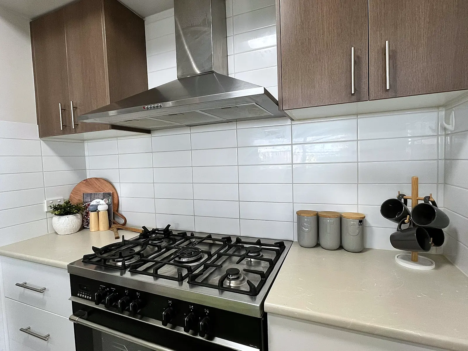 Kitchen bench styled with canisters and greenery in a Doreen home