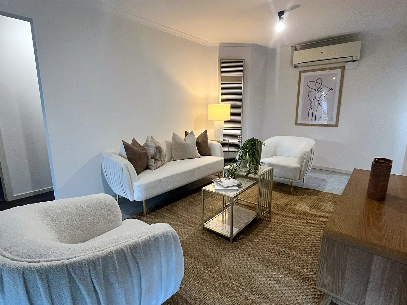Lounge styled with boucle sofa and lamp in an Epping home