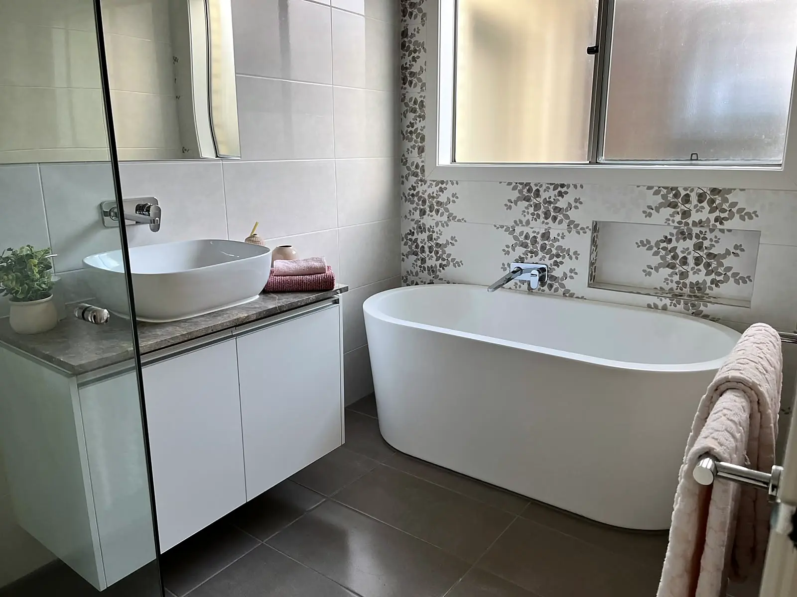 Bathroom with freestanding bath styled with towels in a Fraser Rise home