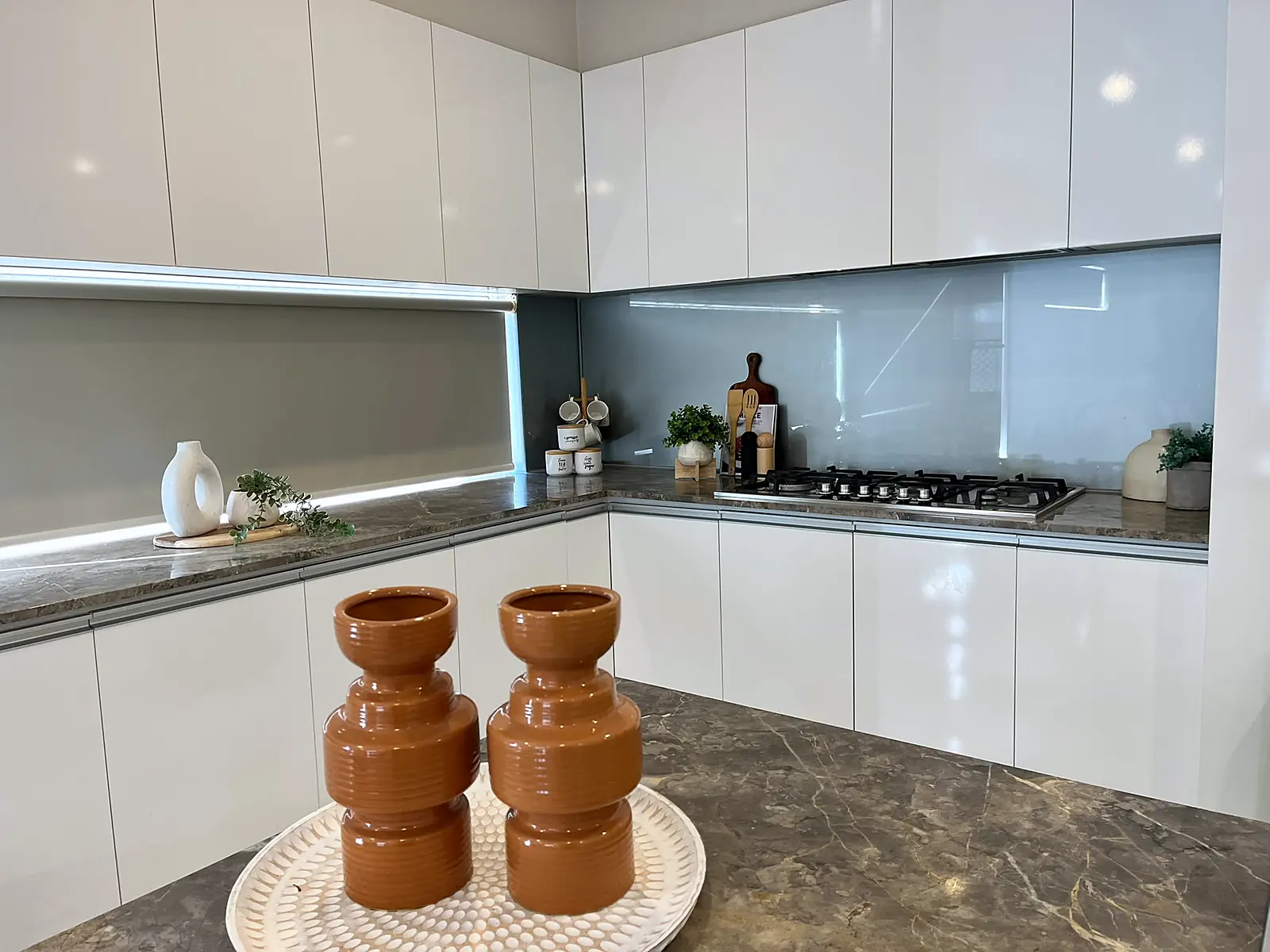 White kitchen with stone island styled for sale in a Fraser Rise home
