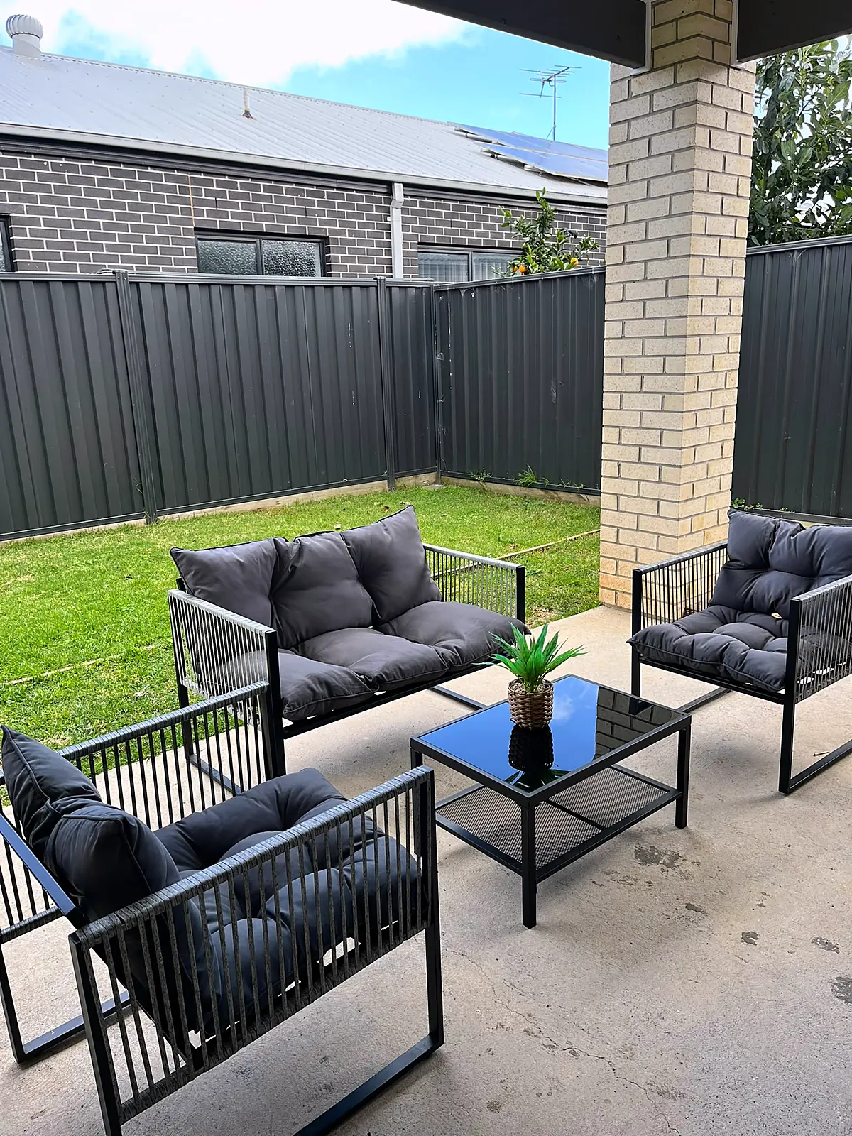 Covered outdoor area staged with a lounge setting in a Fraser Rise home