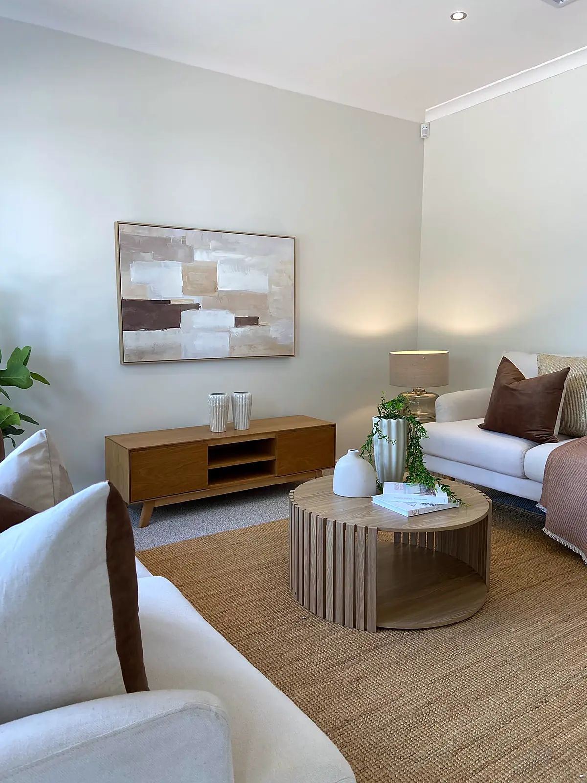 Timber coffee table and TV unit in a staged Harkness living room