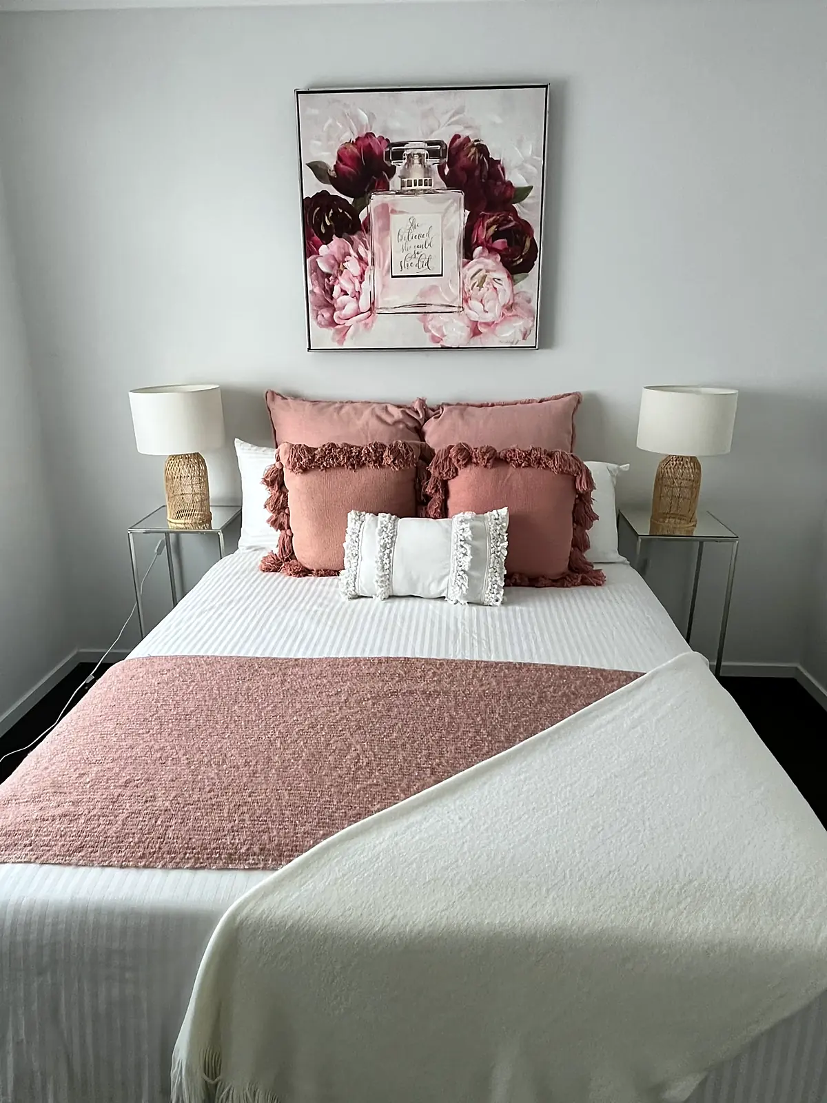 Bedroom styled with blush cushions and floral artwork in a Hillside home
