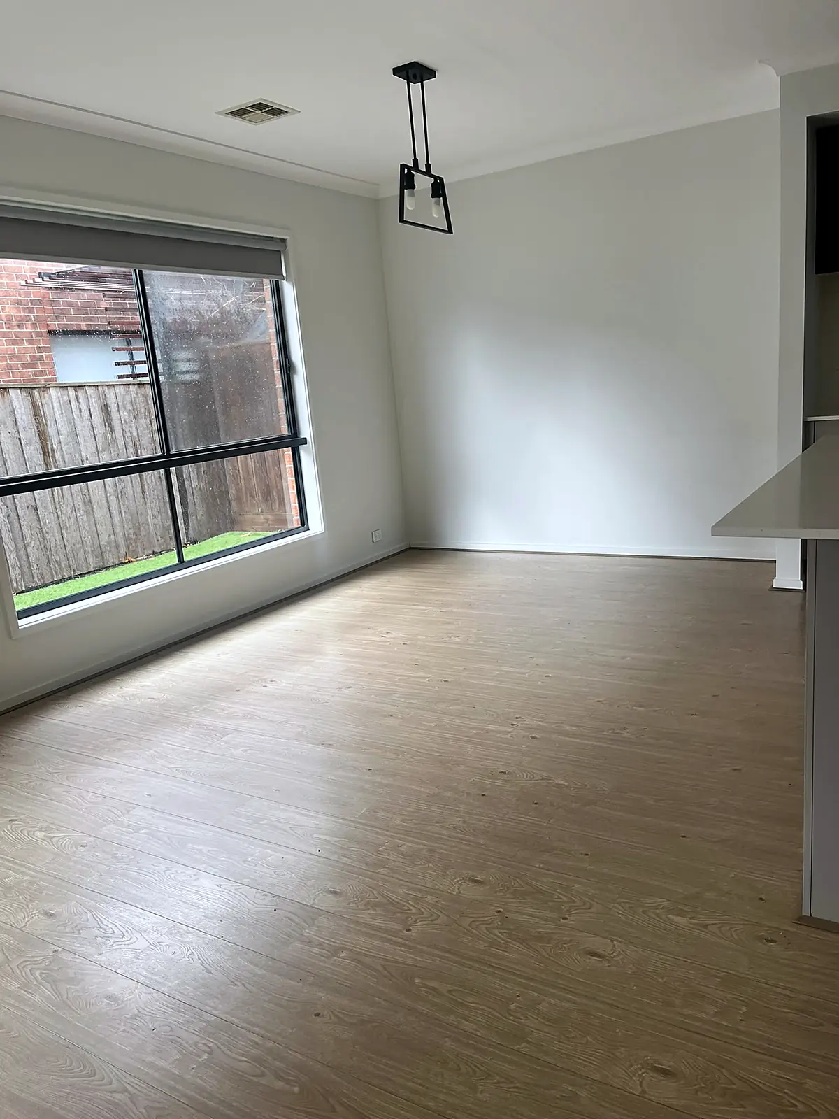 Empty dining area with pendant light before staging in a Hillside home