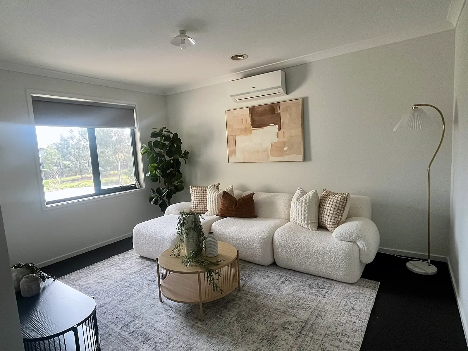 Second lounge staged with boucle sofa and arc floor lamp in a Hillside home
