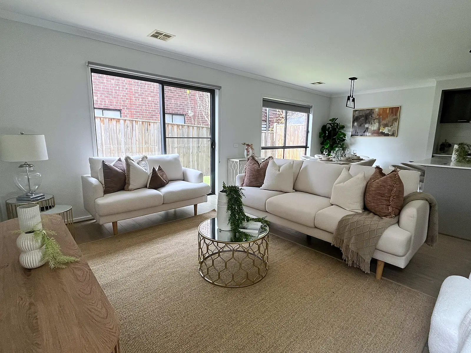 Two cream sofas and gold coffee table in a staged Hillside living room