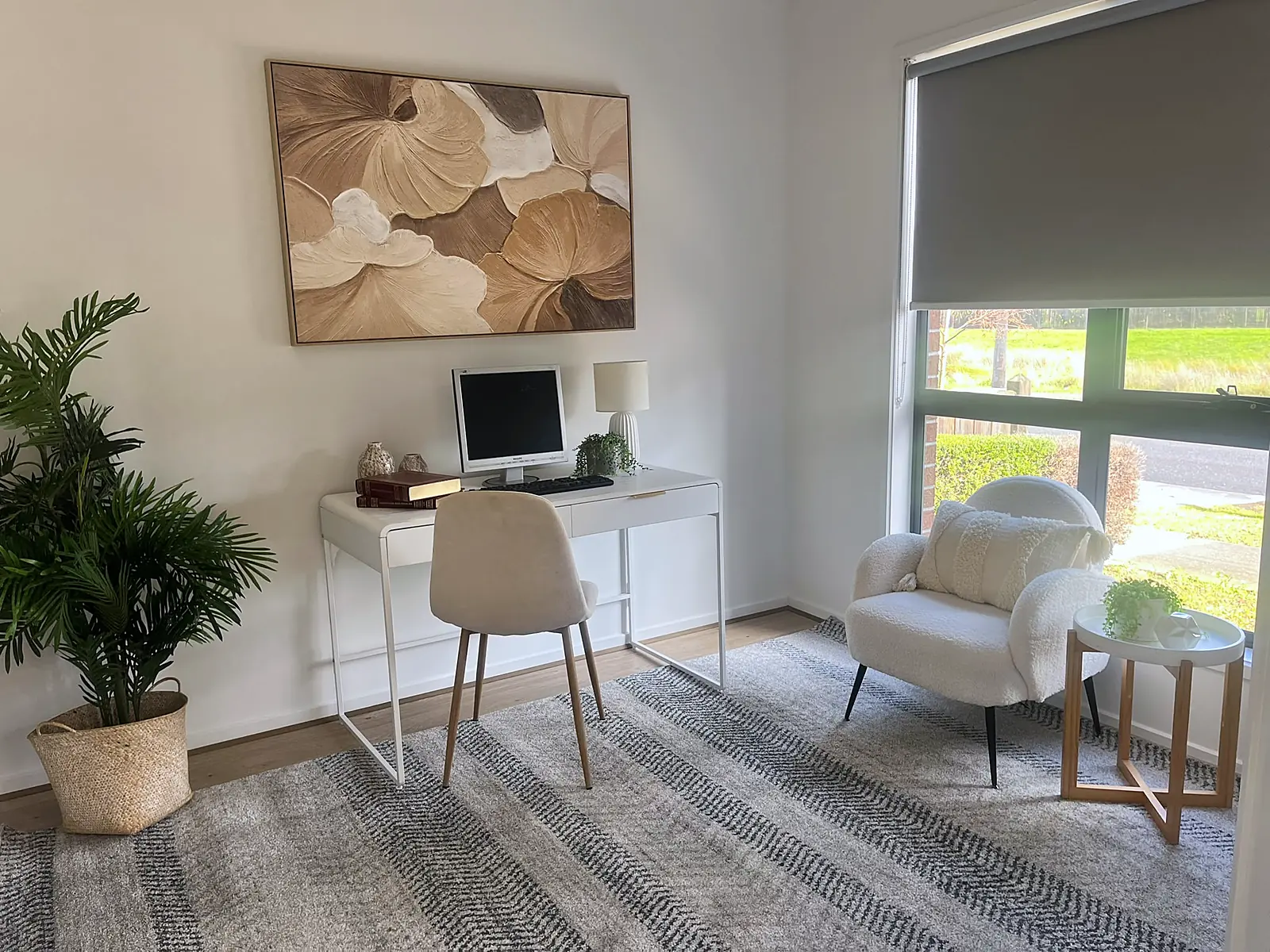Study styled with white desk, armchair and botanical artwork in a Hillside home