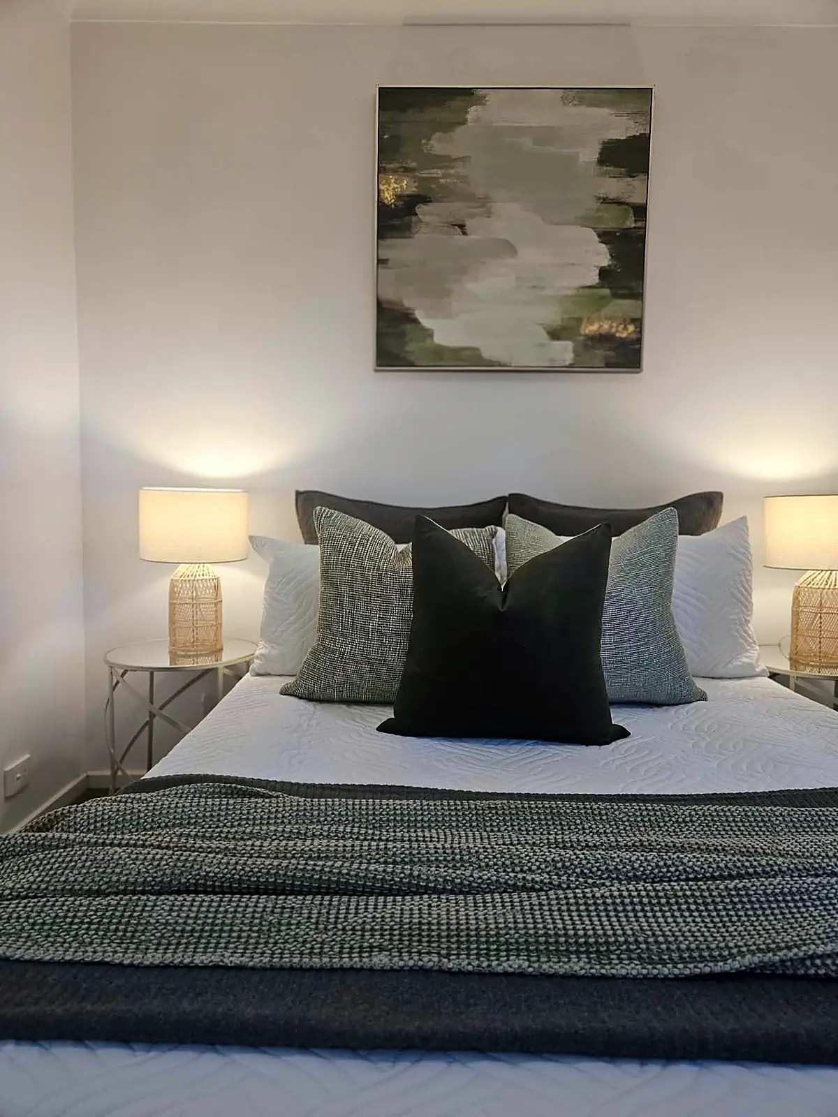 Bedroom staged with green-grey linen and abstract artwork in Hoppers Crossing