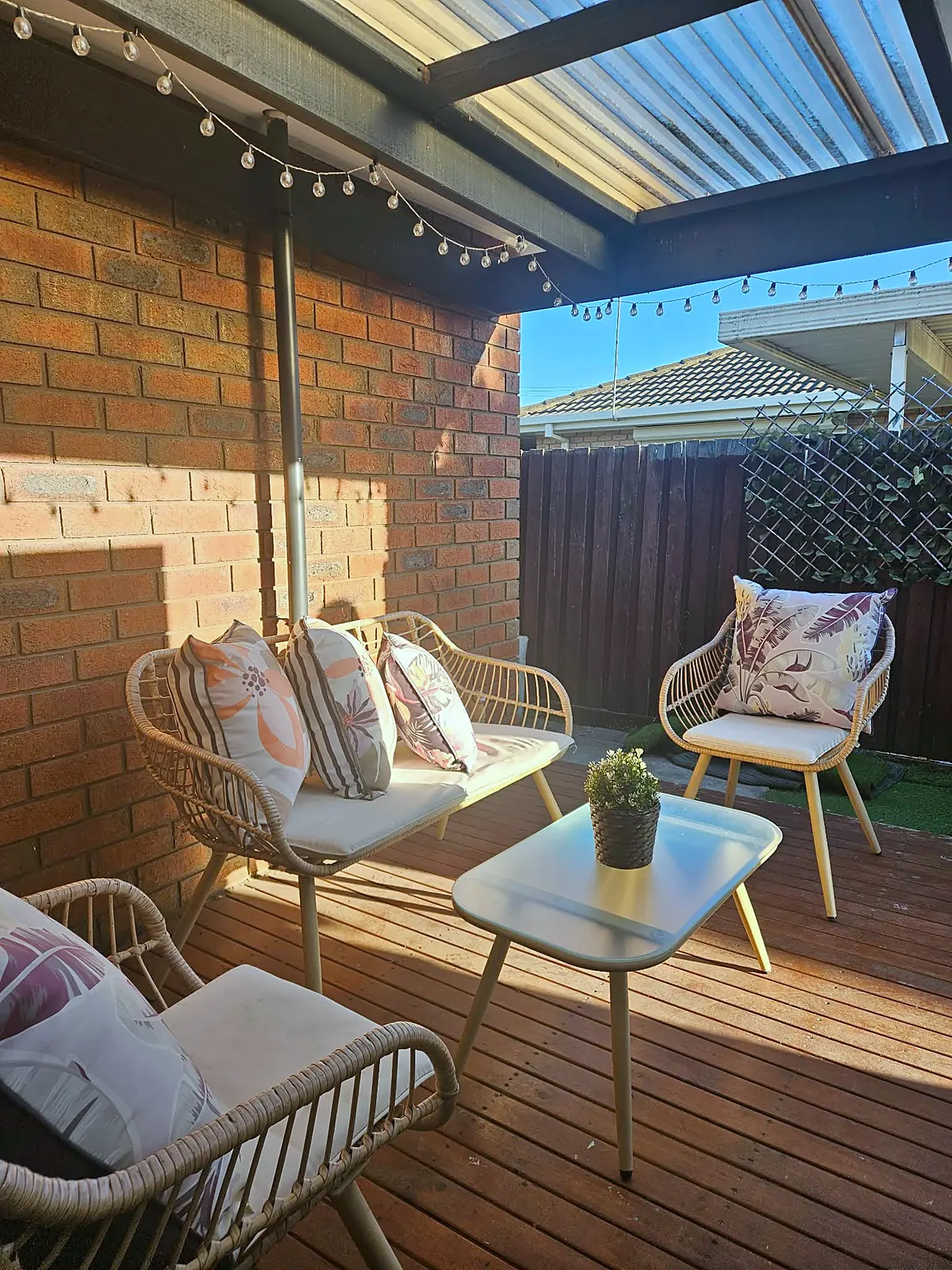 Covered deck styled with rattan outdoor setting in a Hoppers Crossing home