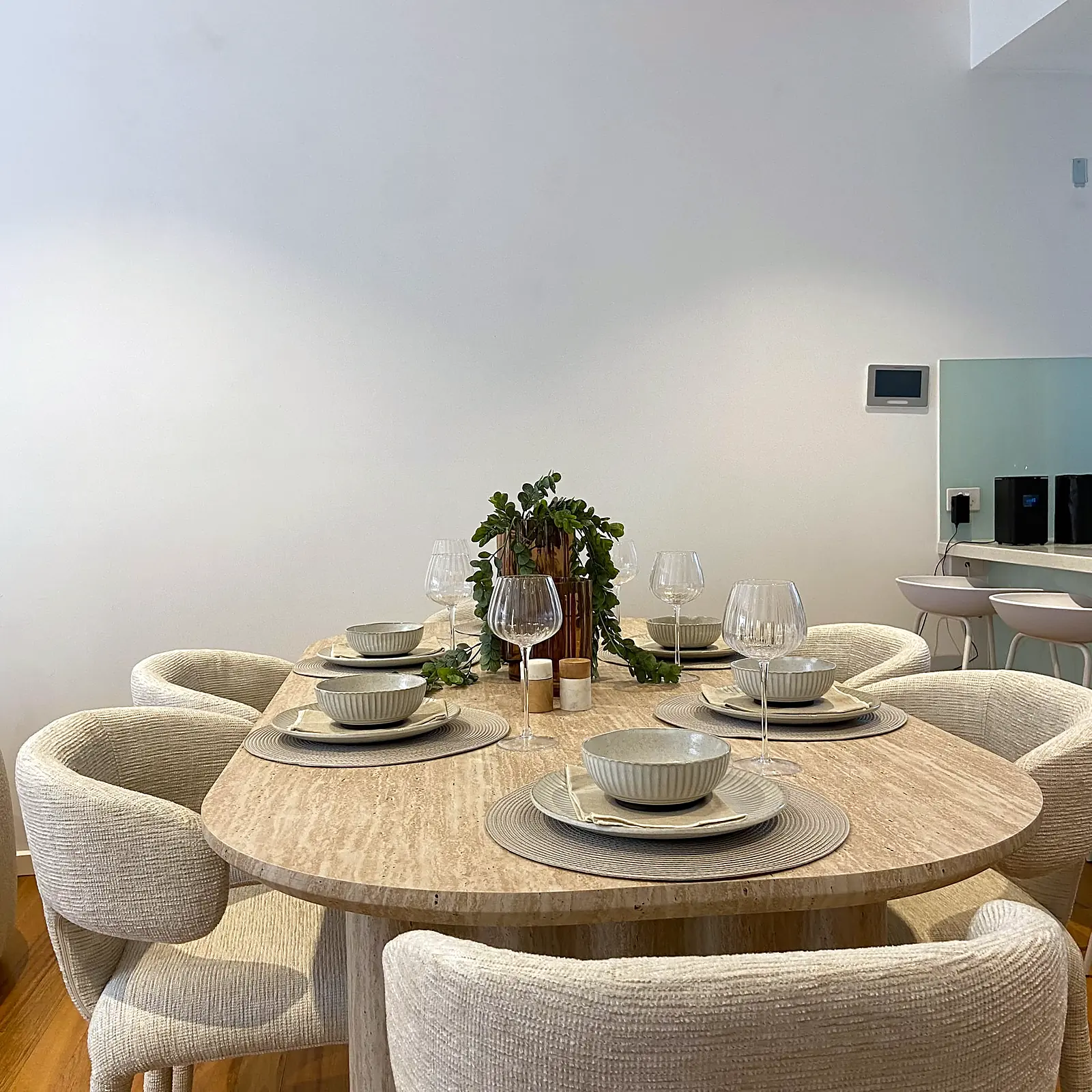 Oval dining table with curved upholstered chairs in a staged Kew townhouse