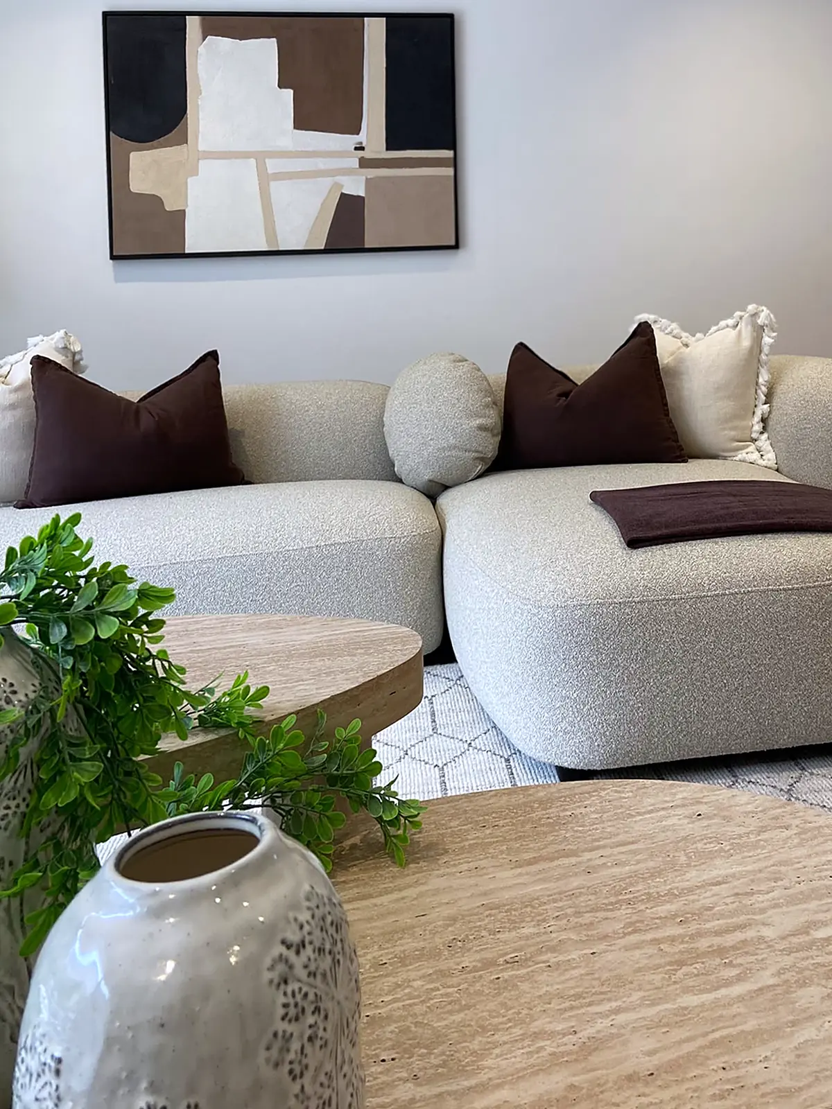 Curved boucle sofa and abstract artwork in a staged Kew living room