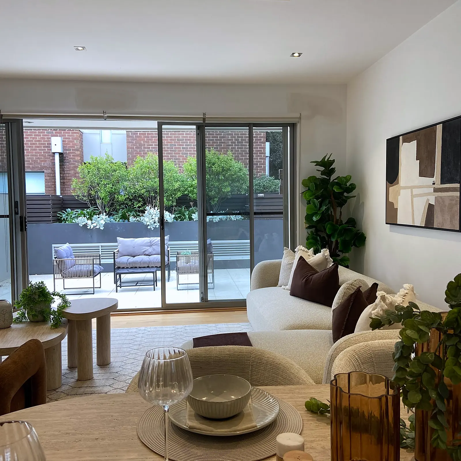 Open-plan living and dining area looking out to the courtyard in a staged Kew townhouse
