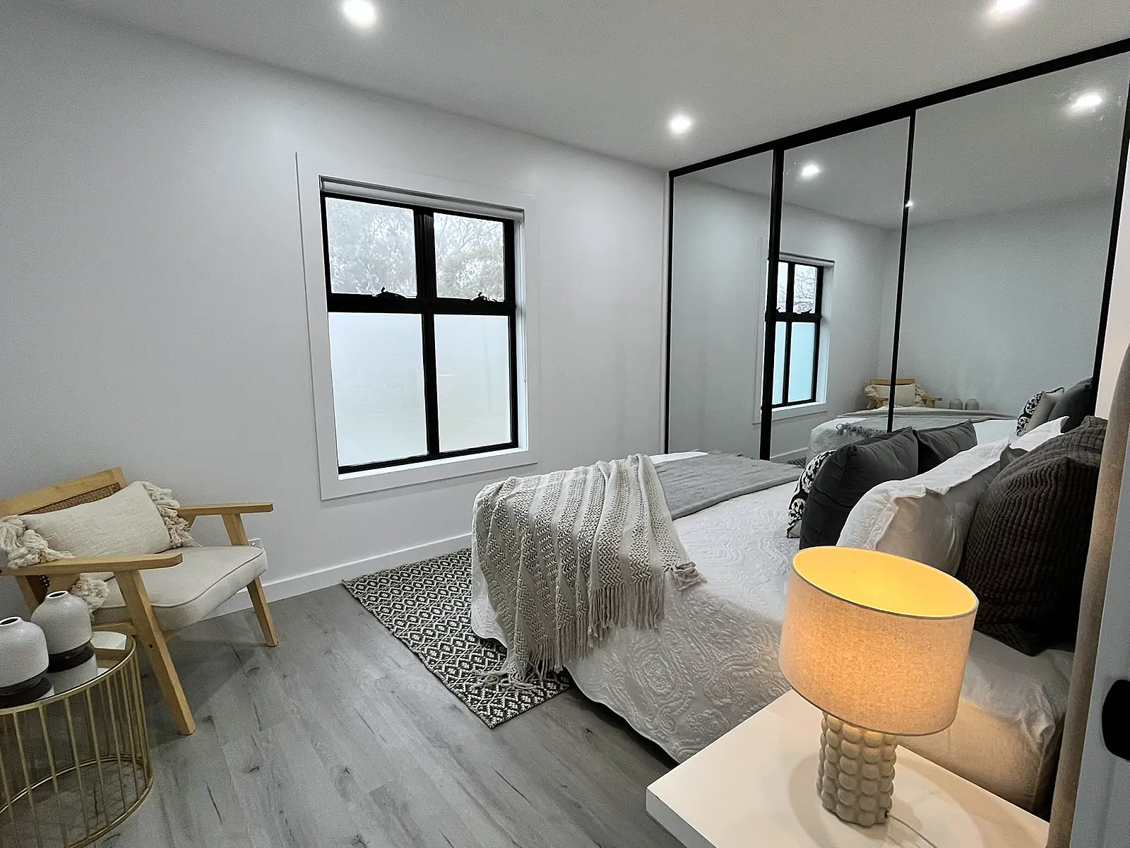 Main bedroom with mirrored wardrobe staged in a Laverton home