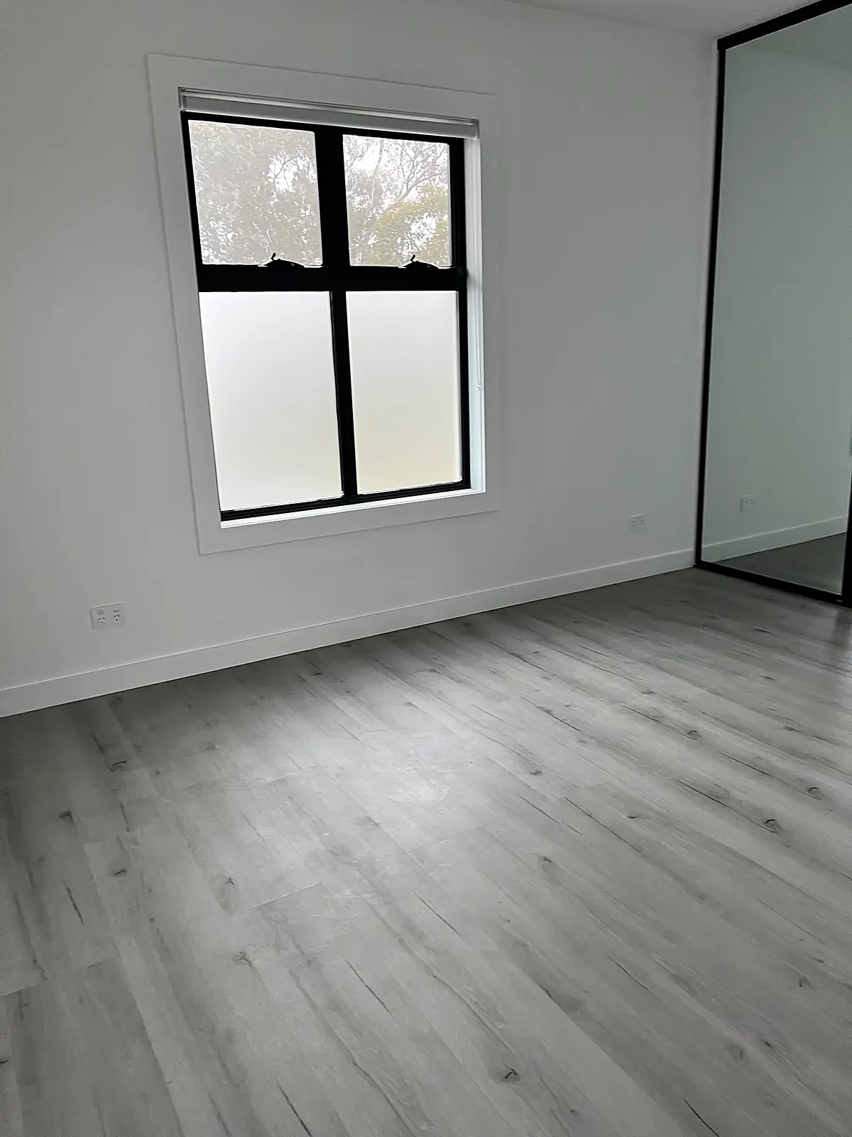 Empty bedroom with mirrored wardrobe before staging in a Laverton home