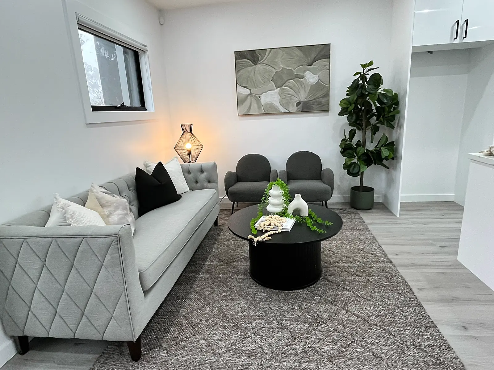 Lounge styled with grey sofa and round coffee table in a Laverton home
