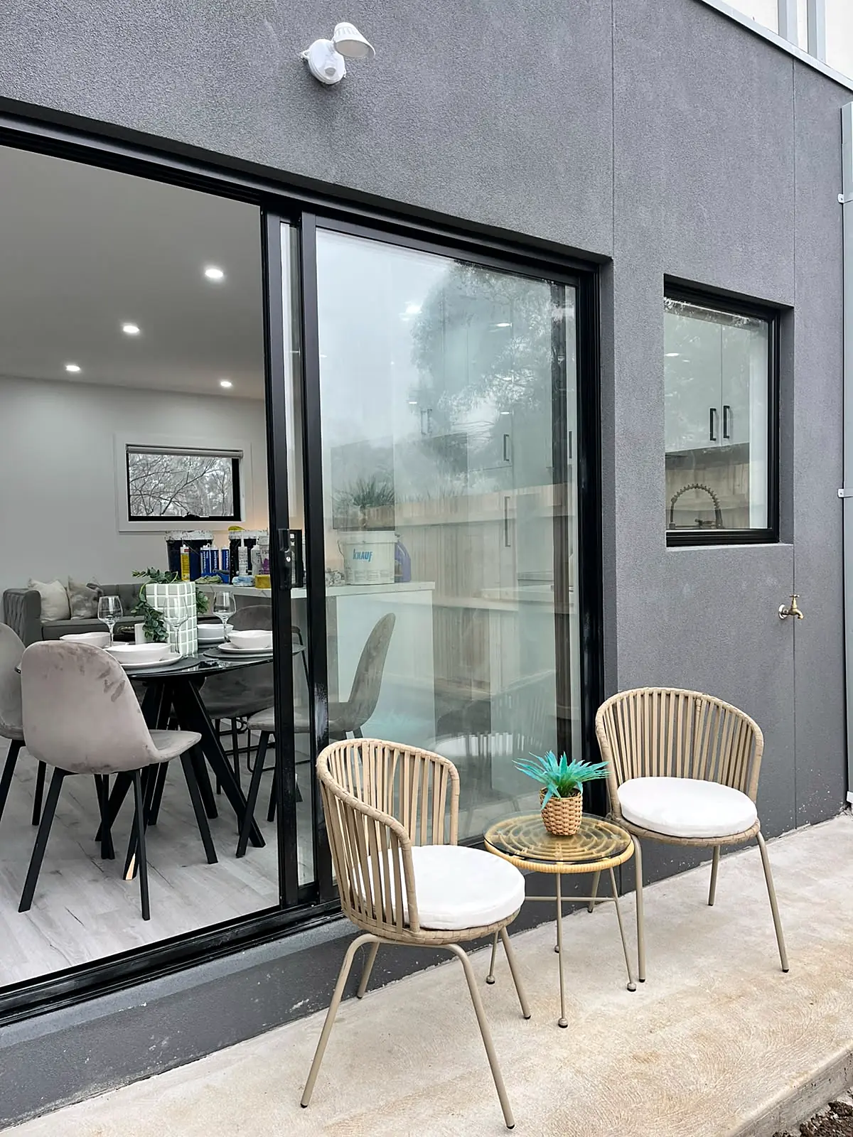 Courtyard staged with two chairs and a small table in a Laverton home