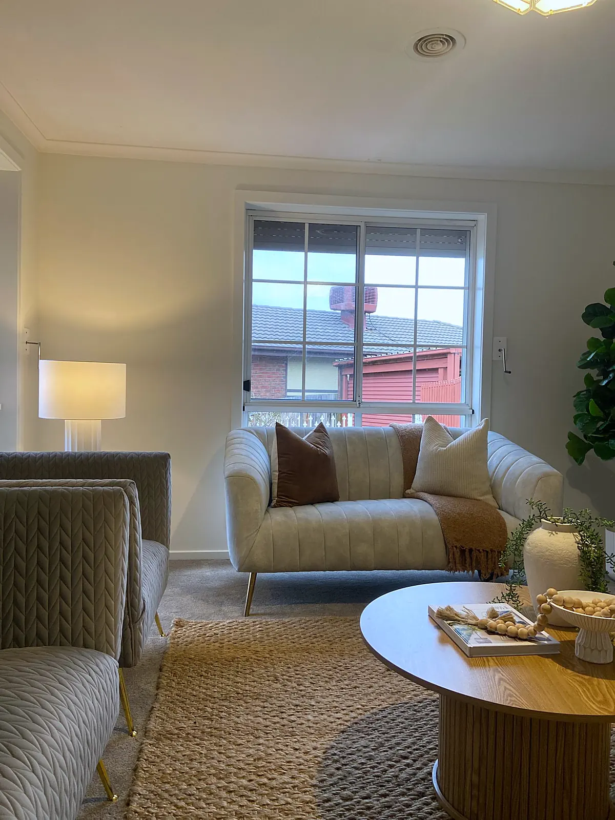Sitting room staged with sofa and round coffee table in a Meadow Heights home