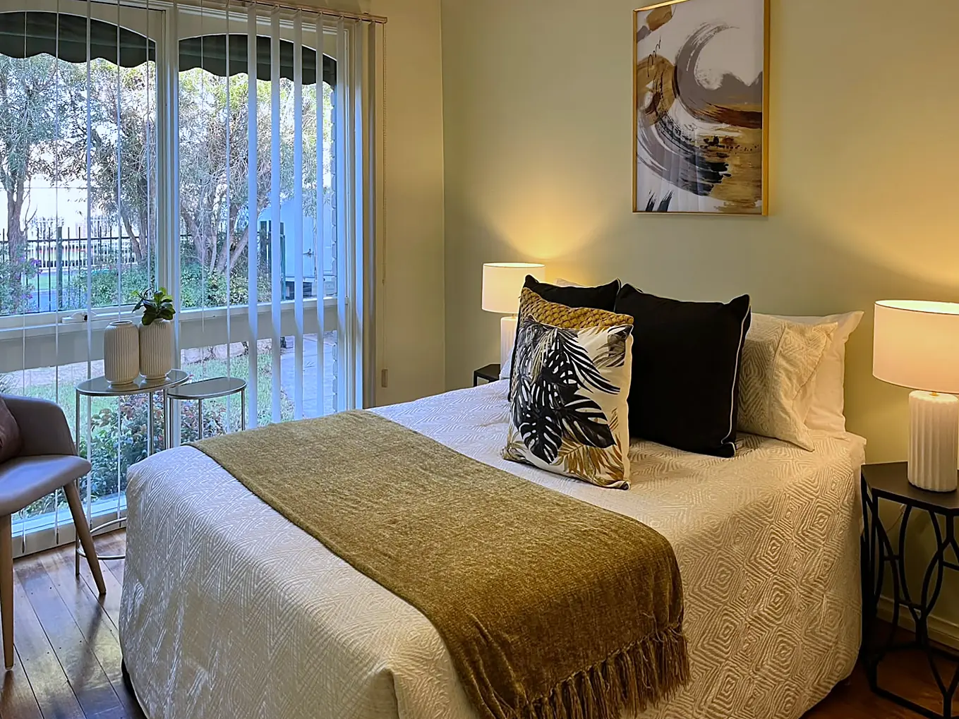Main bedroom with garden outlook staged in cream and olive in a Melton home