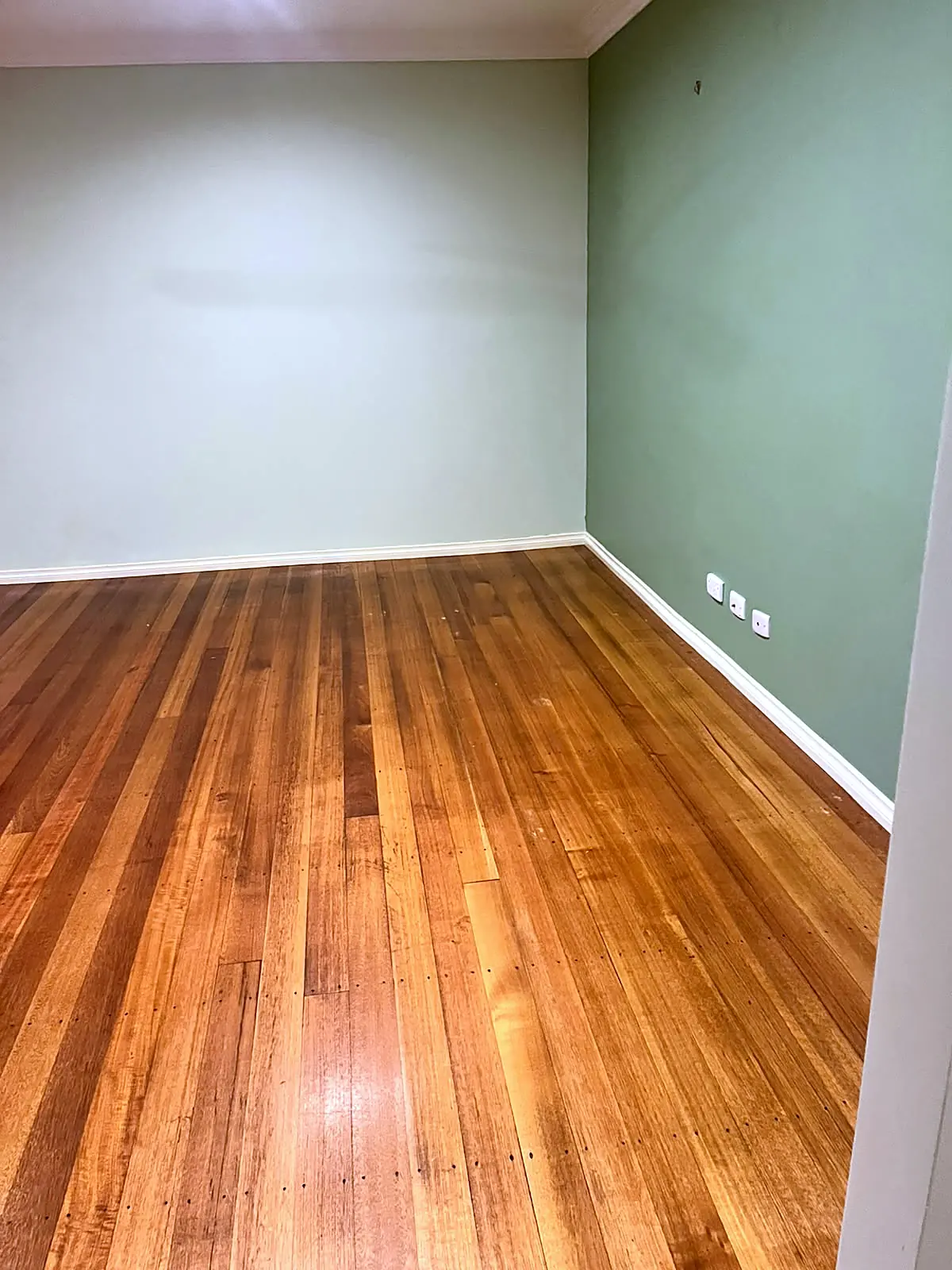 Empty room with polished timber floor before staging in a Melton home
