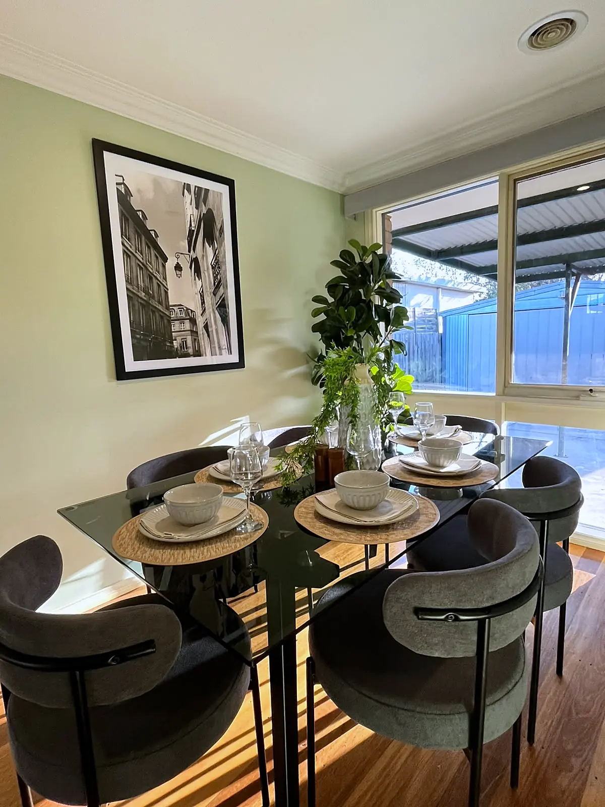 Dining table by the windows in a staged Melton home